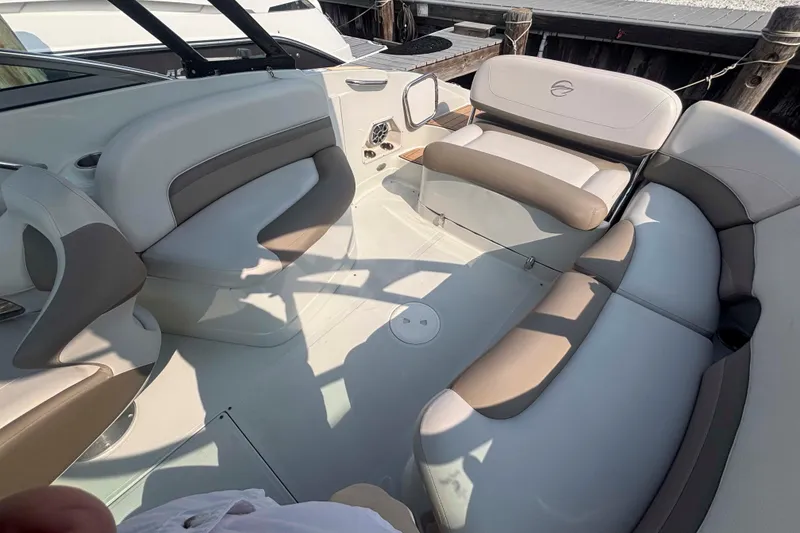 Slide: The Image of 2014 Crownline 285 SS boat interior with beige and gray seating arrangement. - 9