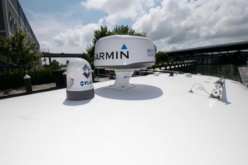 Slide: The Image of 2023 Sea Hunt Ultra 265 SE boat with Garmin and FLIR equipment on deck. - 16