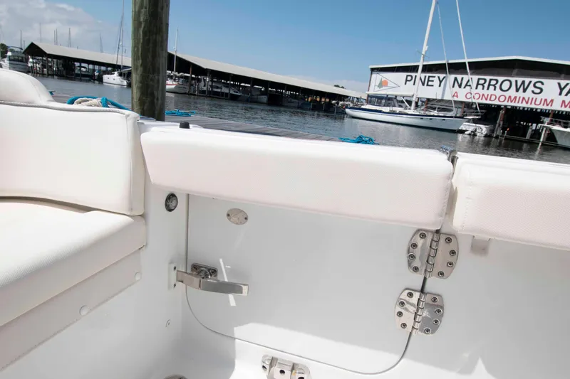 Slide: The Image of 2023 Sea Hunt Ultra 265 SE boat interior with marina view in background. - 18
