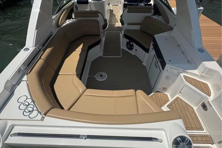 Slide: The Image of 2019 Sea Ray SLX 350 boat interior with tan seating and modern design. - 3
