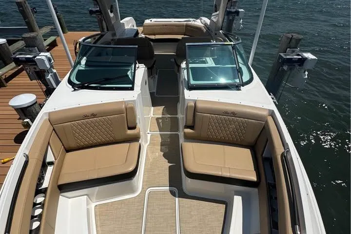 Slide: The Image of 2019 Sea Ray SLX 350 boat interior with tan leather seating and dual windshields. - 4