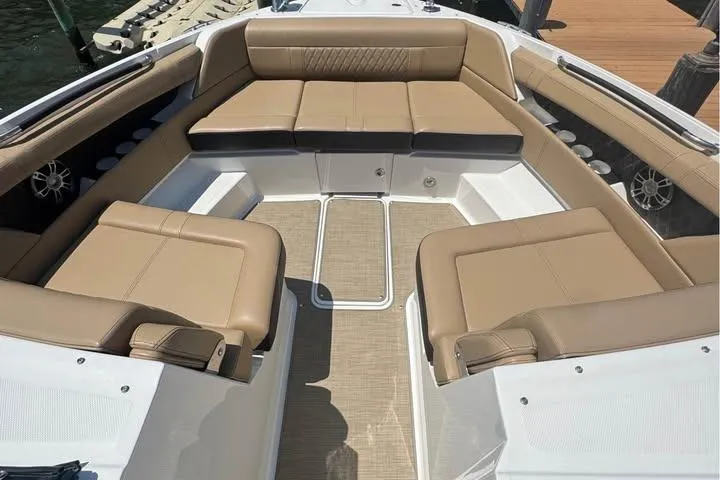 Slide: The Image of 2019 Sea Ray SLX 350 boat interior with tan leather seating and spacious layout. - 5