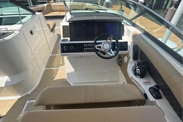 Slide: The Image of 2019 Sea Ray SLX 350 boat interior with modern dashboard and steering wheel. - 6
