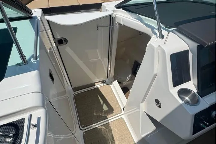 Slide: The Image of 2019 Sea Ray SLX 350 boat interior with open cabin door and sleek design. - 7