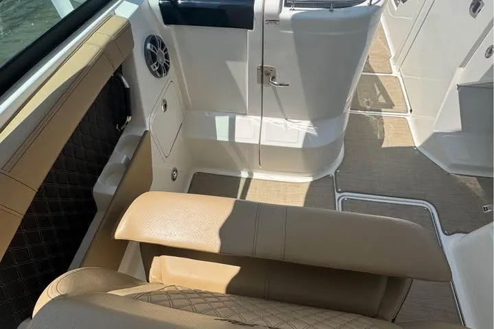 Slide: The Image of 2019 Sea Ray SLX 350 interior with beige seating and modern design elements. - 8