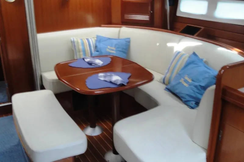 Slide: The Image of Interior of 2006 Beneteau Oceanis Clipper 423 yacht with cozy seating and wooden table. - 16