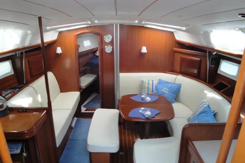 Slide: The Image of Interior of 2006 Beneteau Oceanis Clipper 423 yacht with cozy seating and wooden finishes. - 17