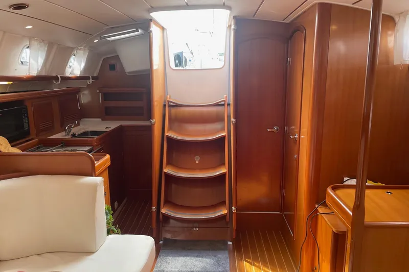 Slide: The Image of Interior of 2006 Beneteau Oceanis Clipper 423 yacht with wooden finish and compact kitchen. - 21