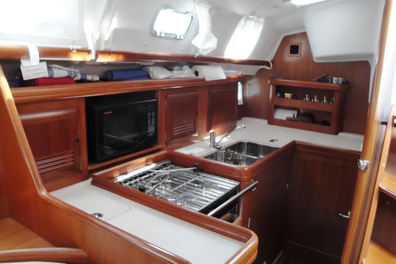 Slide: The Image of Interior of 2006 Beneteau Oceanis Clipper 423 yacht kitchen with wood cabinetry and appliances. - 23