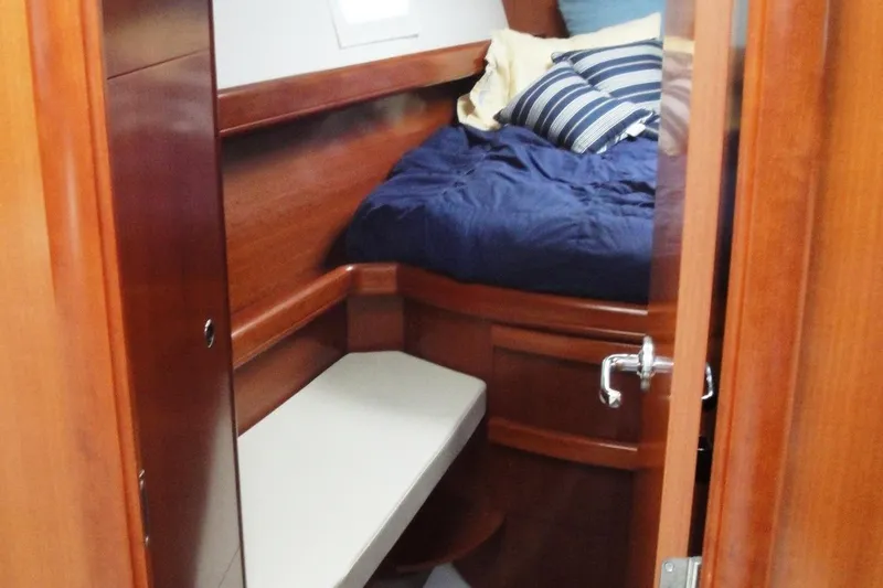 Slide: The Image of Interior cabin of 2006 Beneteau Oceanis Clipper 423 with wooden finish and cozy bedding. - 26