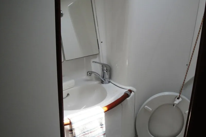 Slide: The Image of Bathroom interior of 2006 Beneteau Oceanis Clipper 423 yacht, featuring sink and toilet. - 28