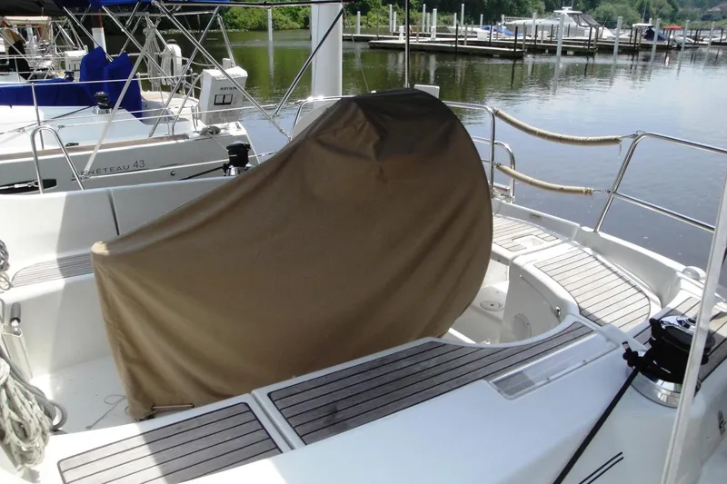 Slide: The Image of 2006 Beneteau Oceanis Clipper 423 sailboat cockpit with covered wheel, docked at marina. - 6