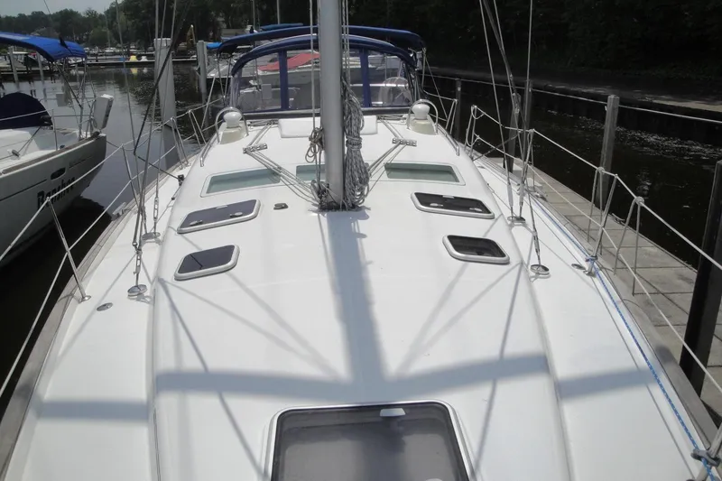 Slide: The Image of 2006 Beneteau Oceanis Clipper 423 sailboat docked, showcasing deck and rigging. - 9