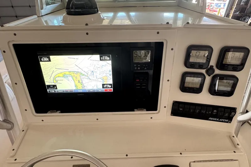 Slide: The Image of 2007 Regulator 32 Forward Seating boat dashboard with navigation and control instruments. - 13
