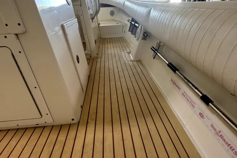 Slide: The Image of 2007 Regulator 32 Forward Seating boat interior with wood flooring and white seating. - 14