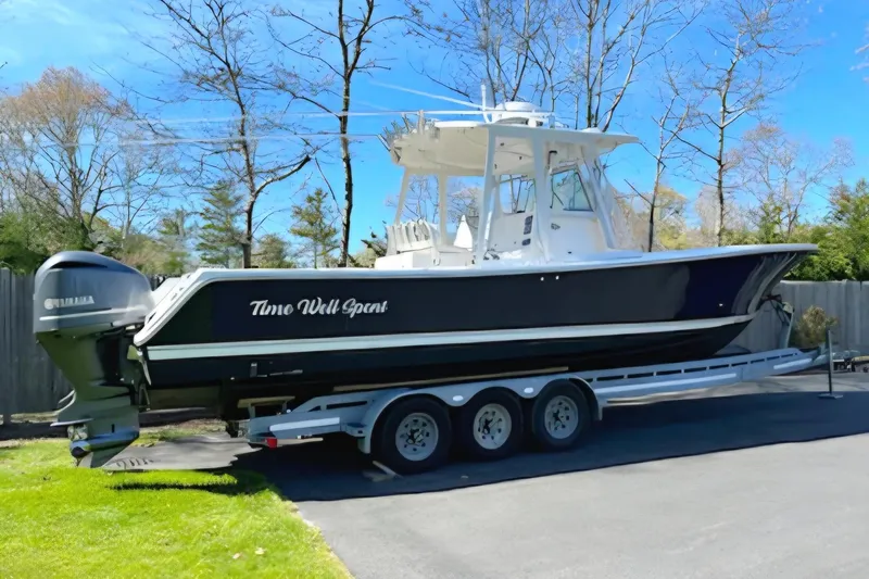 Slide: The Image of 2008 Regulator 32 Forward Seating boat on trailer, parked outdoors. - 2