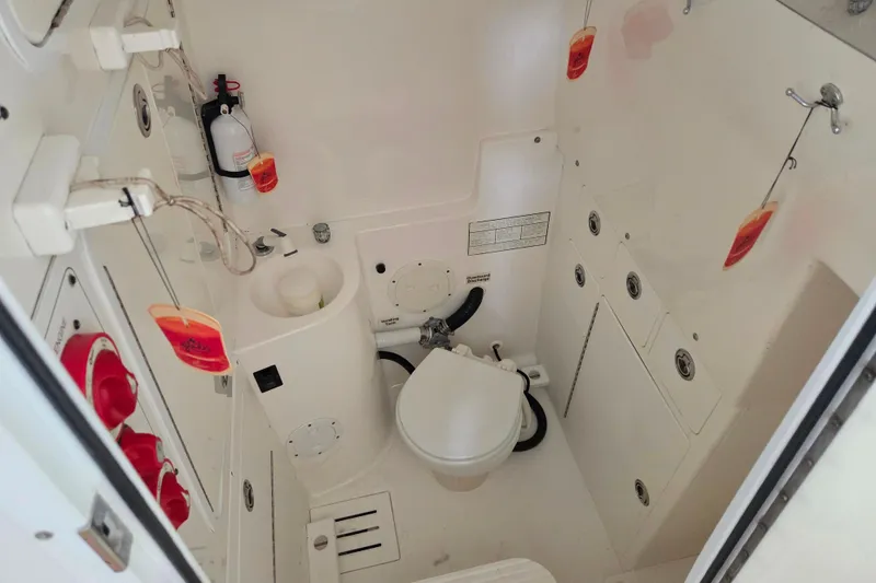 Slide: The Image of 2007 Regulator 32 Forward Seating boat interior with toilet and safety equipment. - 5
