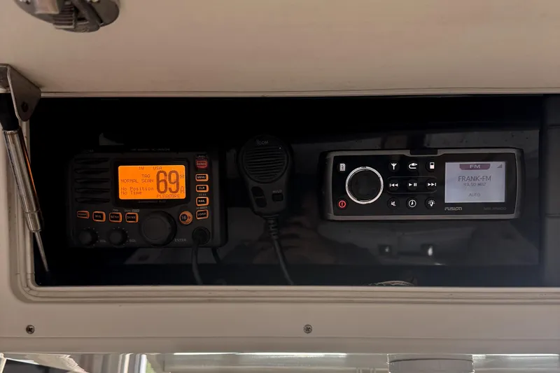 Slide: The Image of 2007 Regulator 32 Forward Seating boat dashboard with radio and communication equipment. - 7