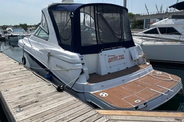 Slide: The Image of 2005 Four Winns 378 Vista yacht docked at marina under clear blue sky. - 13