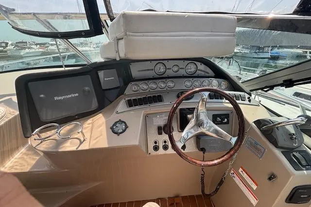 Slide: The Image of 2005 Four Winns 378 Vista yacht docked at marina, rear view with covered deck. - 14