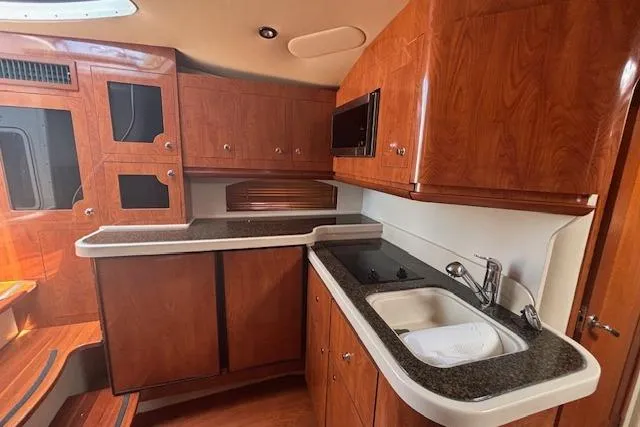 Slide: The Image of Interior of 2005 Four Winns 378 Vista yacht with cozy seating and wooden table. - 3