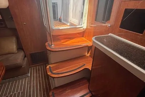 Slide: The Image of 2005 Four Winns 378 Vista yacht interior with wooden cabinetry and modern kitchen amenities. - 7