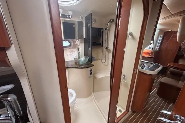 Slide: The Image of 2005 Four Winns 378 Vista yacht interior with open mini fridge and wooden cabinetry. - 8
