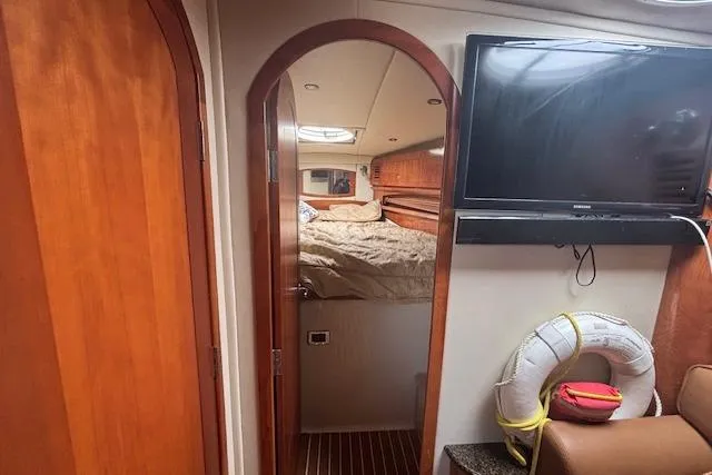 Slide: The Image of Interior of 2005 Four Winns 378 Vista yacht with wooden steps and seating area. - 9