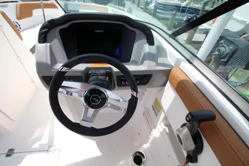 Slide: The Image of 2024 Chaparral 235 SSi OB boat dashboard with steering wheel and controls. - 13