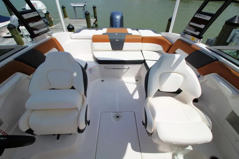 Slide: The Image of 2024 Chaparral 235 SSi OB boat interior with white and tan seating. - 15