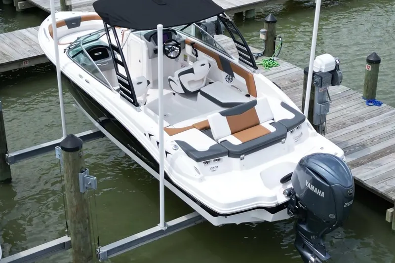 Slide: The Image of 2024 Chaparral 235 SSi OB boat docked with Yamaha outboard motor. - 2