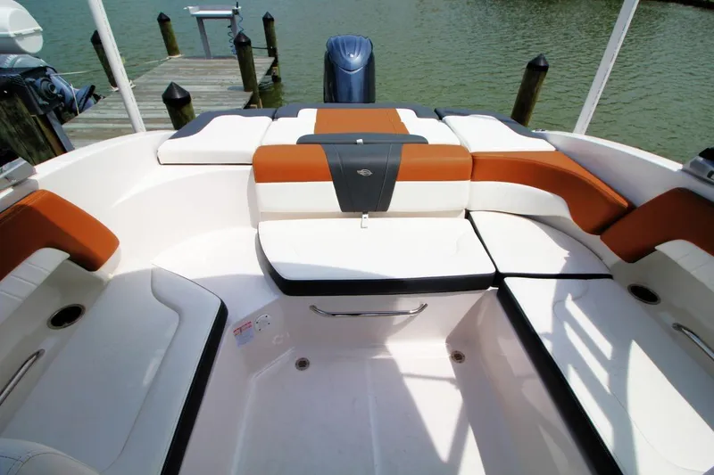 Slide: The Image of 2024 Chaparral 235 SSi OB boat interior with stylish seating and water view. - 9