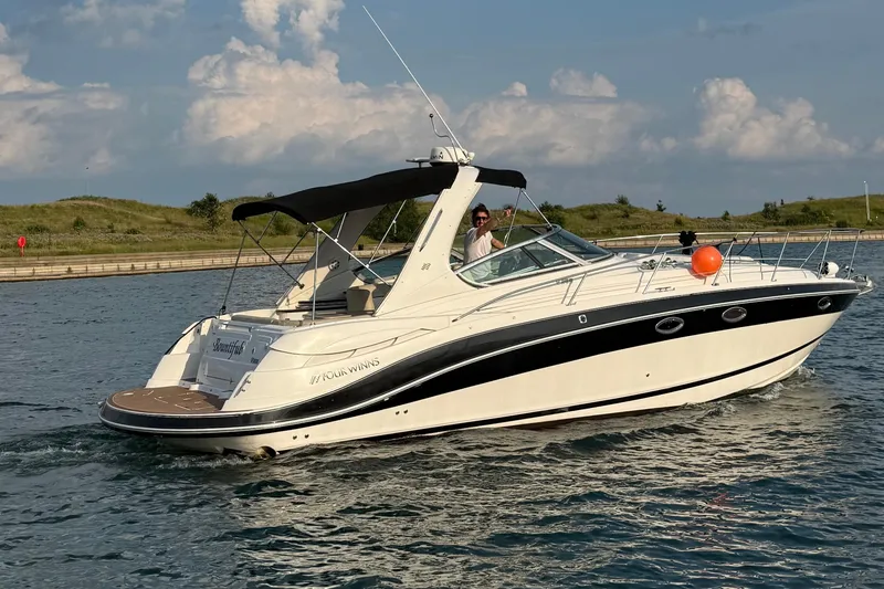 Slide: The Image of 2008 Four Winns V358 boat cruising on a sunny day with scenic background. - 0