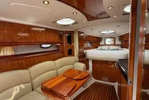 Slide: The Image of Luxurious interior of 2008 Four Winns V358 yacht with elegant wood finishes and plush seating. - 1
