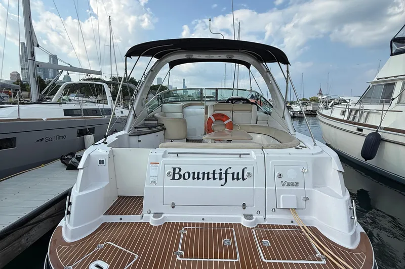 Slide: The Image of 2008 Four Winns V358 boat named "Bountiful" docked at a marina. - 2