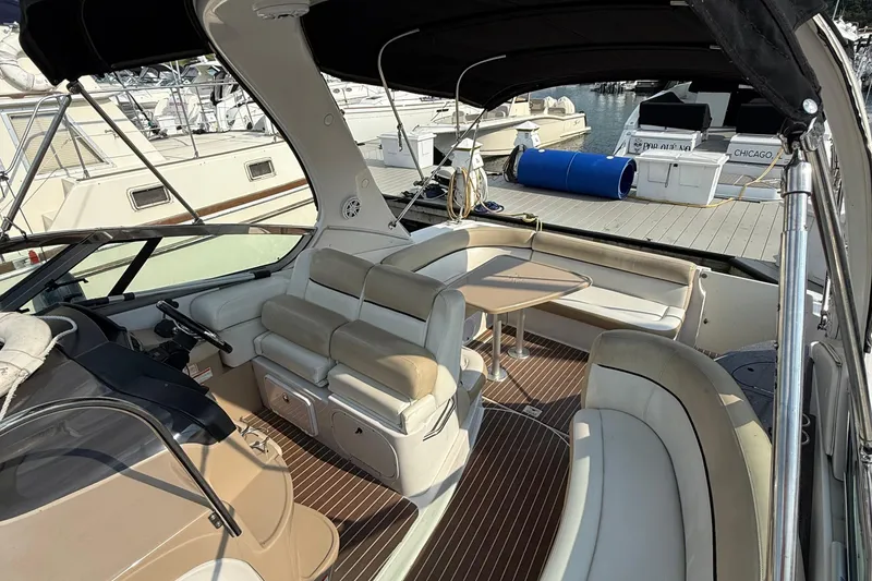 Slide: The Image of 2008 Four Winns V358 boat interior with seating and table, docked at marina. - 6