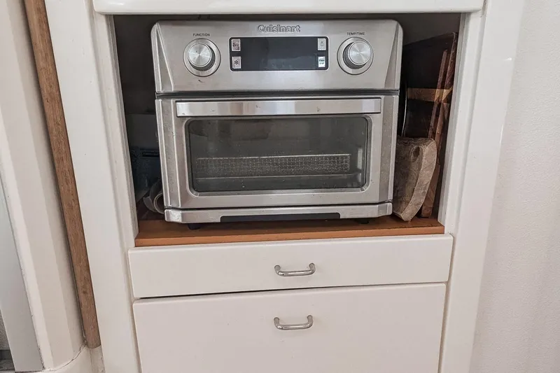 Slide: The Image of Cuisinart toaster oven in white kitchen cabinet, Voyage 440, 2001 model. - 12