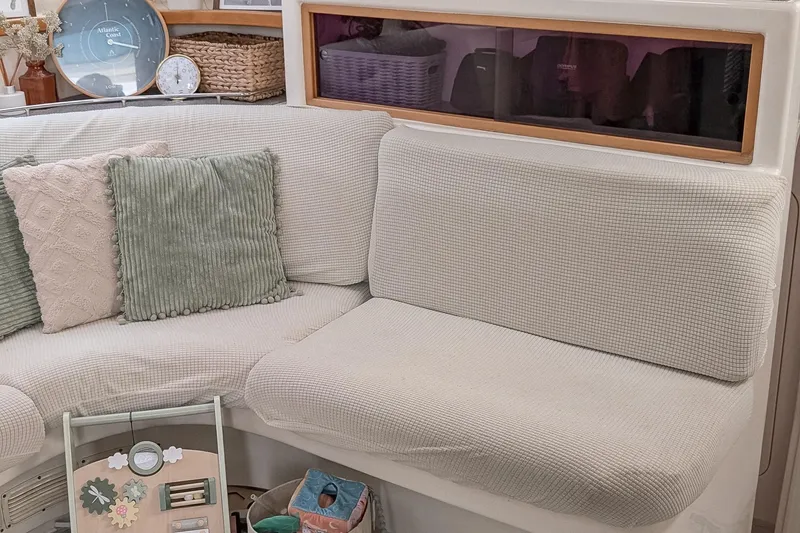 Slide: The Image of Cozy interior of a 2001 Voyage 440 yacht with cushioned seating and decorative pillows. - 14