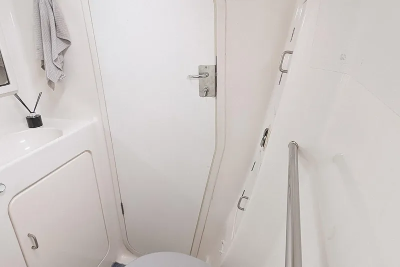 Slide: The Image of Compact bathroom interior of 2001 Voyage 440 yacht, featuring sink, towel, and shower area. - 19