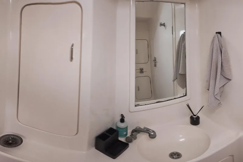 Slide: The Image of Bathroom interior of 2001 Voyage 440 yacht with sink, mirror, and towel. - 20