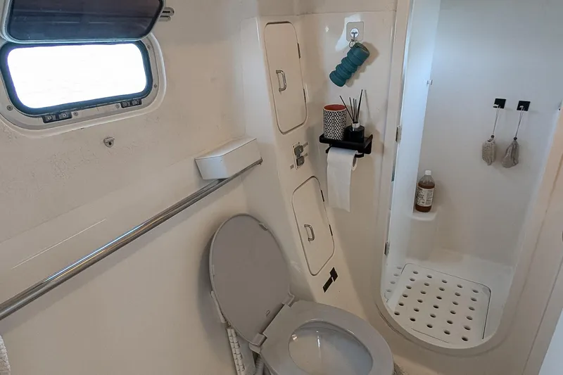 Slide: The Image of Compact bathroom in a 2001 Voyage 440 yacht, featuring a toilet and shower area. - 22
