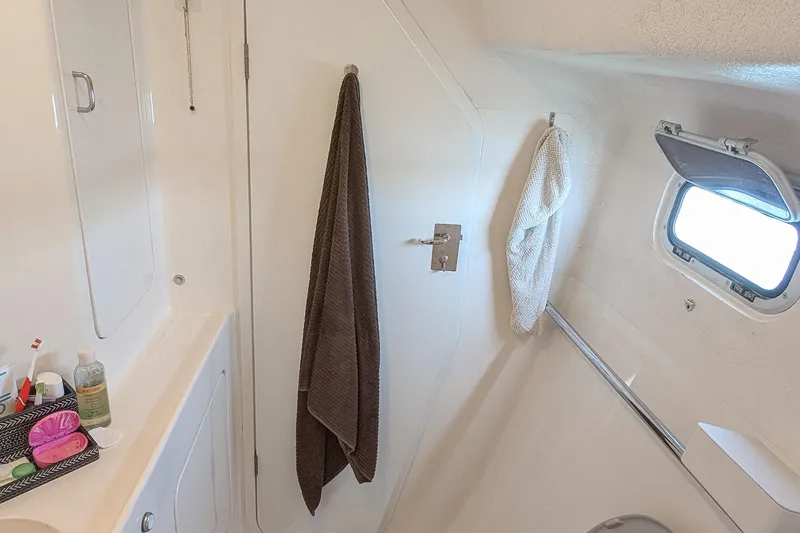 Slide: The Image of Bathroom interior of 2001 Voyage 440 yacht with towels and toiletries. - 23