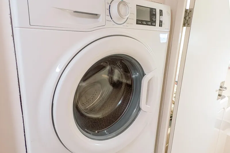 Slide: The Image of Front-loading washing machine in a compact laundry space. - 29