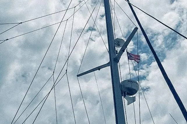 Slide: The Image of Mast and rigging of a 2001 Voyage 440 sailboat against a cloudy sky. - 31