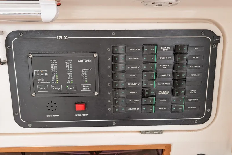 Slide: The Image of Control panel of a 2001 Voyage 440 yacht with Xantrex system and various switches. - 32