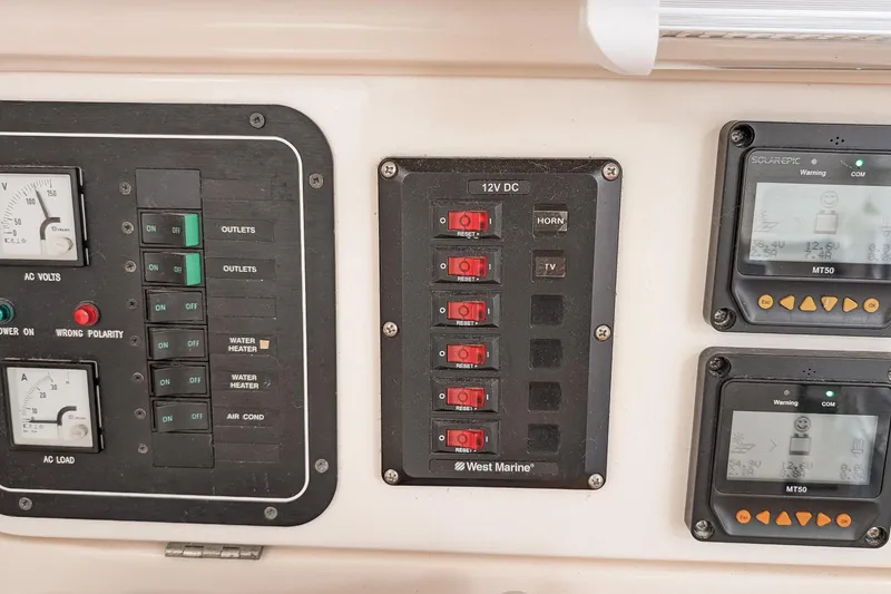 Slide: The Image of Control panel of a 2001 Voyage 440 yacht with switches and gauges. - 33