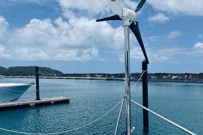 Slide: The Image of Wind turbine on Voyage 440 yacht, 2001 model, docked in a serene marina. - 34