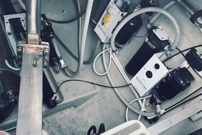 Slide: The Image of Engine compartment of a 2001 Voyage 440 yacht, showcasing mechanical components and wiring. - 36