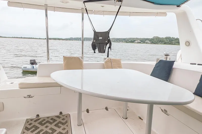 Slide: The Image of Outdoor seating area on a 2001 Voyage 440 catamaran with water view. - 4