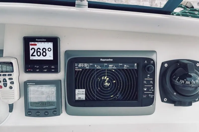 Slide: The Image of Voyage 440 yacht navigation panel with Raymarine instruments, compass, and communication device, 2001 model. - 5